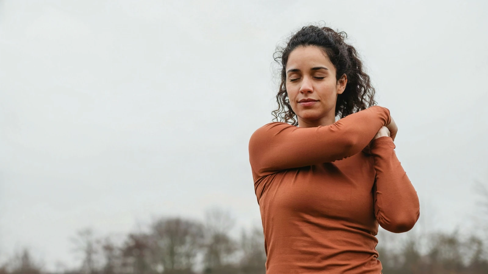 A young woman with her arms crossed over her chest