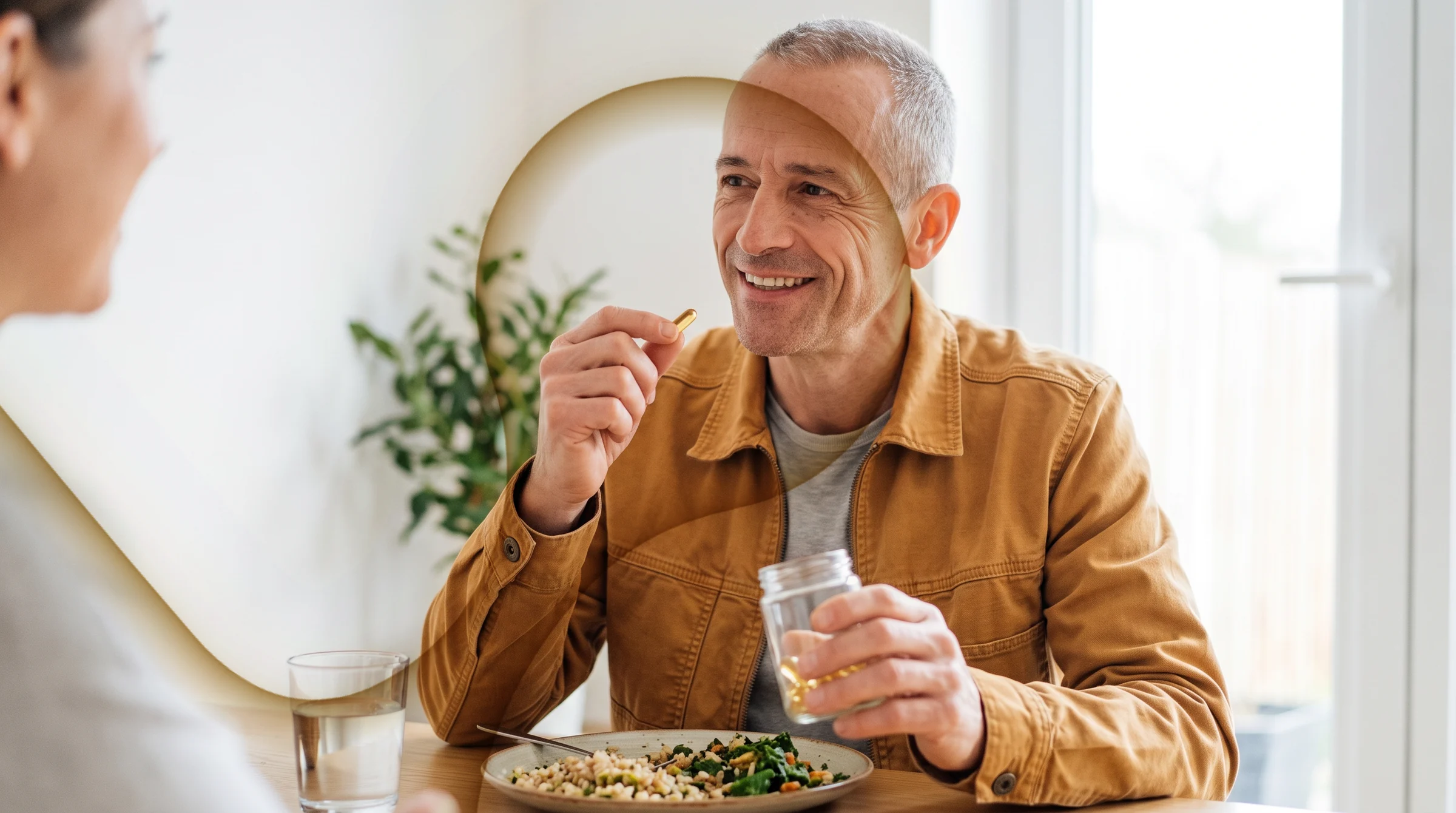 The same man at lunch, taking a capsule from a glass jar